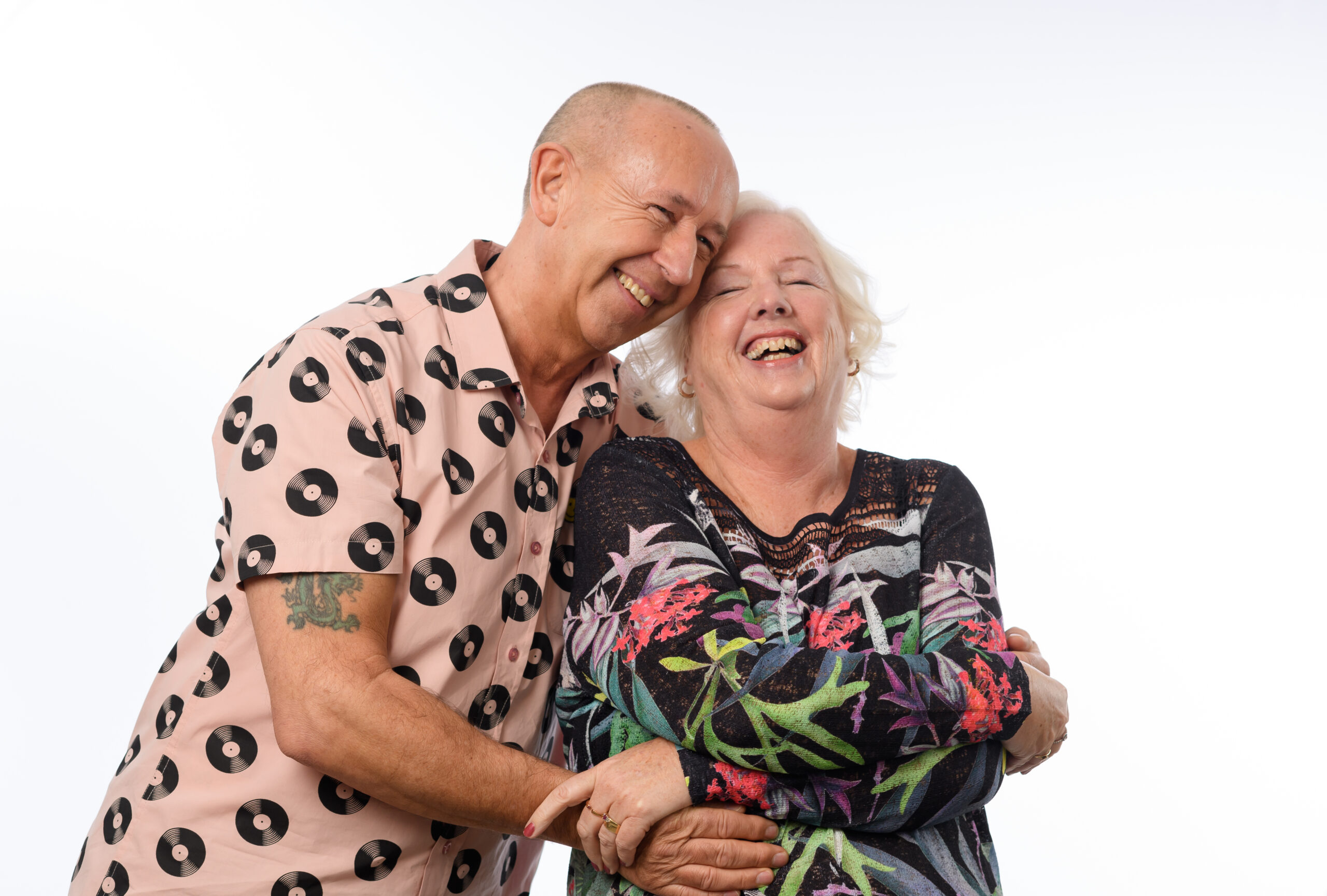 Resident couple Sandra and Roy laughing and hugging