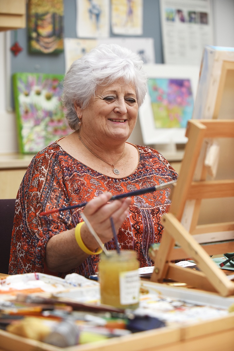 Lady sat at a table painting